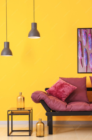 A living room with yellow walls and a purple couch.